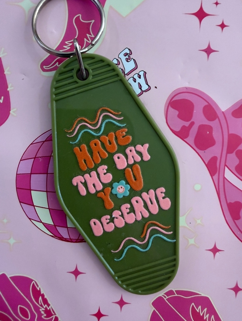 Green Keychain with 'Have The Day You Deserve' Text